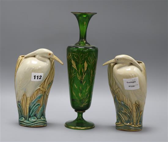 A Bohemian green and gilt glass vase, and a pair of ceramic wall pockets in the form of herons tallest 31cm